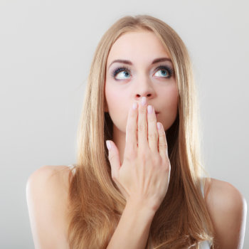 Embarrassed Woman Covering Her Mouth with Her Hand