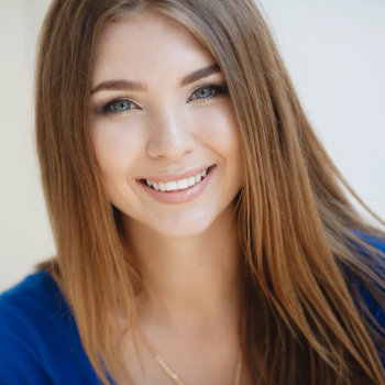 cheerful young woman with a snow white smile