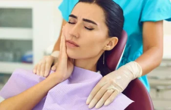Woman with severe toothache during emergency dental visit