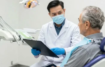 Senior discussing Medicare dental benefits with dentist